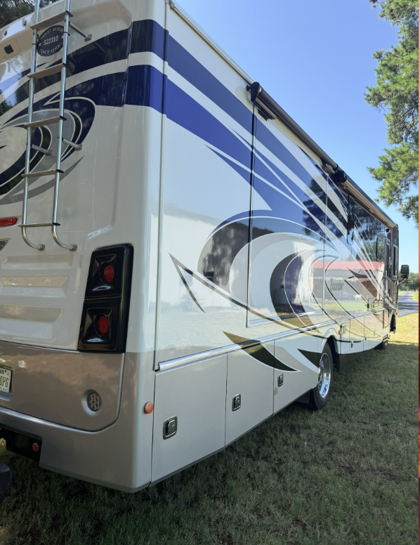 Polished blue and tan motorhome exterior after a full wash