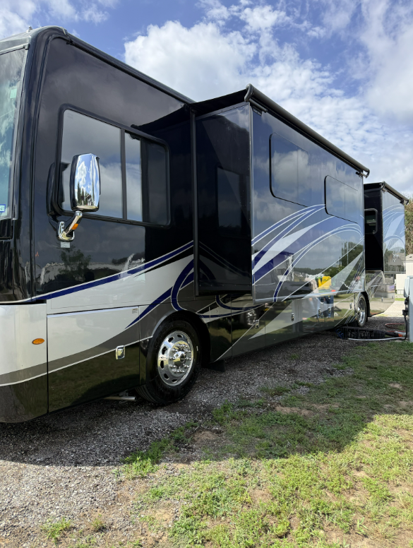 Detailed black and silver diesel pusher parked on the grass